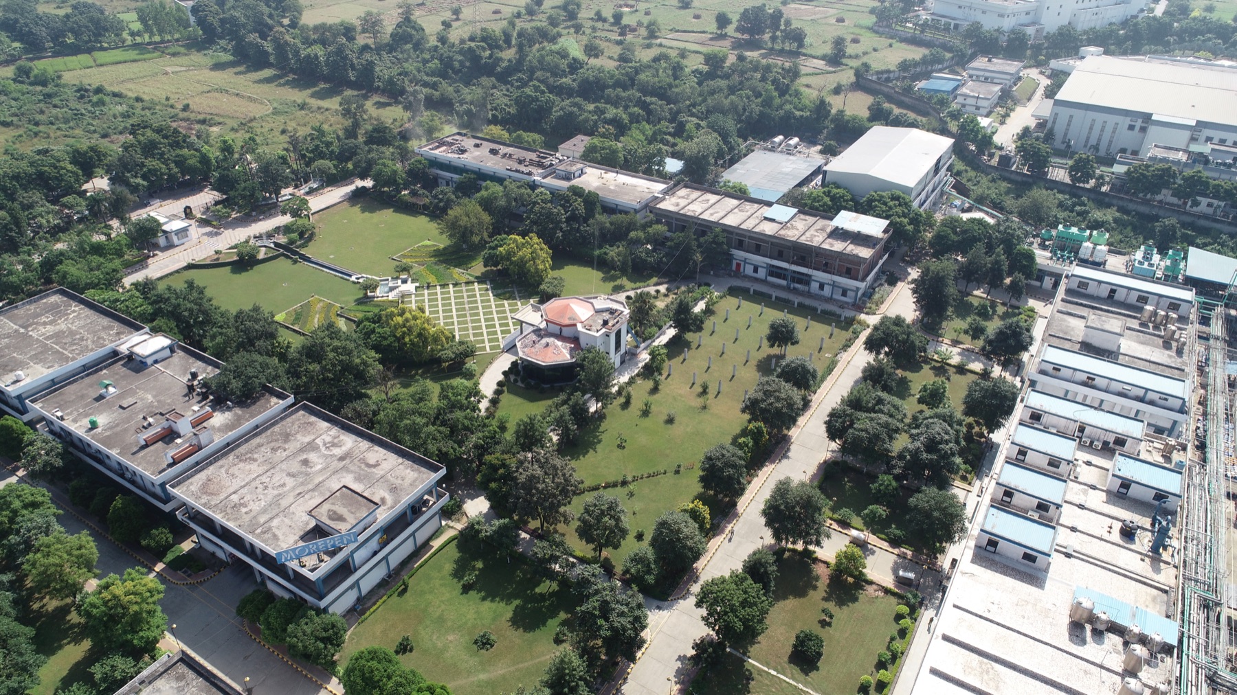 Aerial view of the landscaped Morepen campus with office and plant buildings